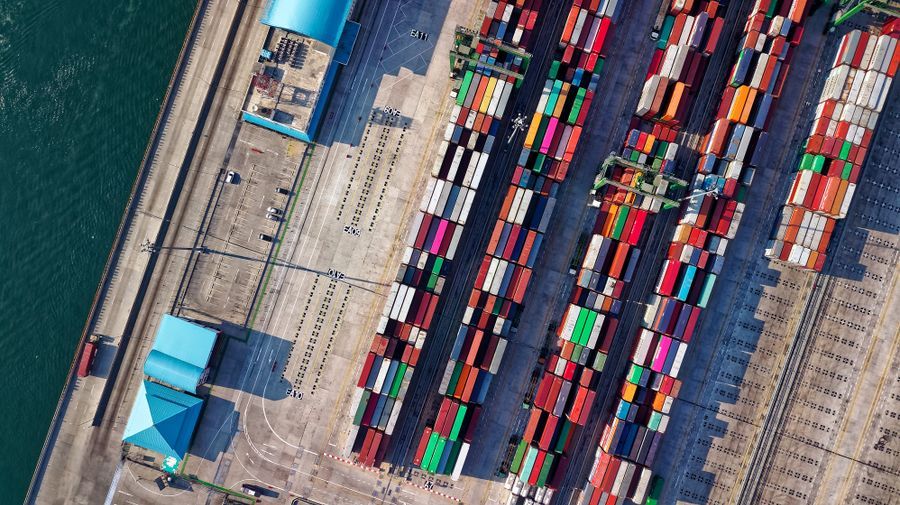 Aerial view of a container terminal, with stacked containers and gantry cranes