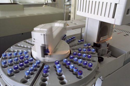 An automated laboratory instrument holding a carousel of sample vials