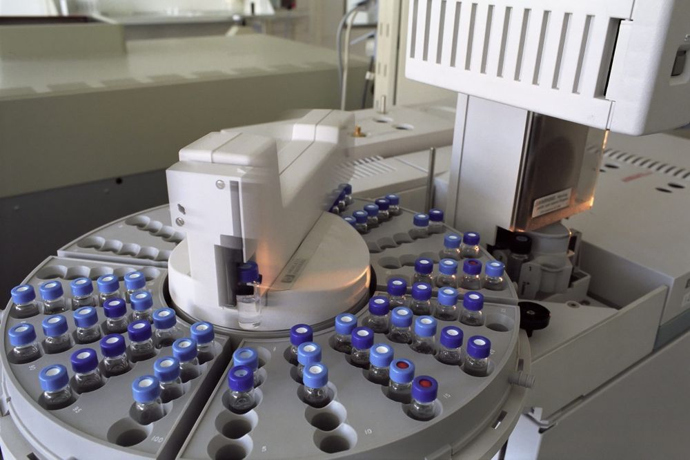 An automated laboratory instrument holding a carousel of sample vials