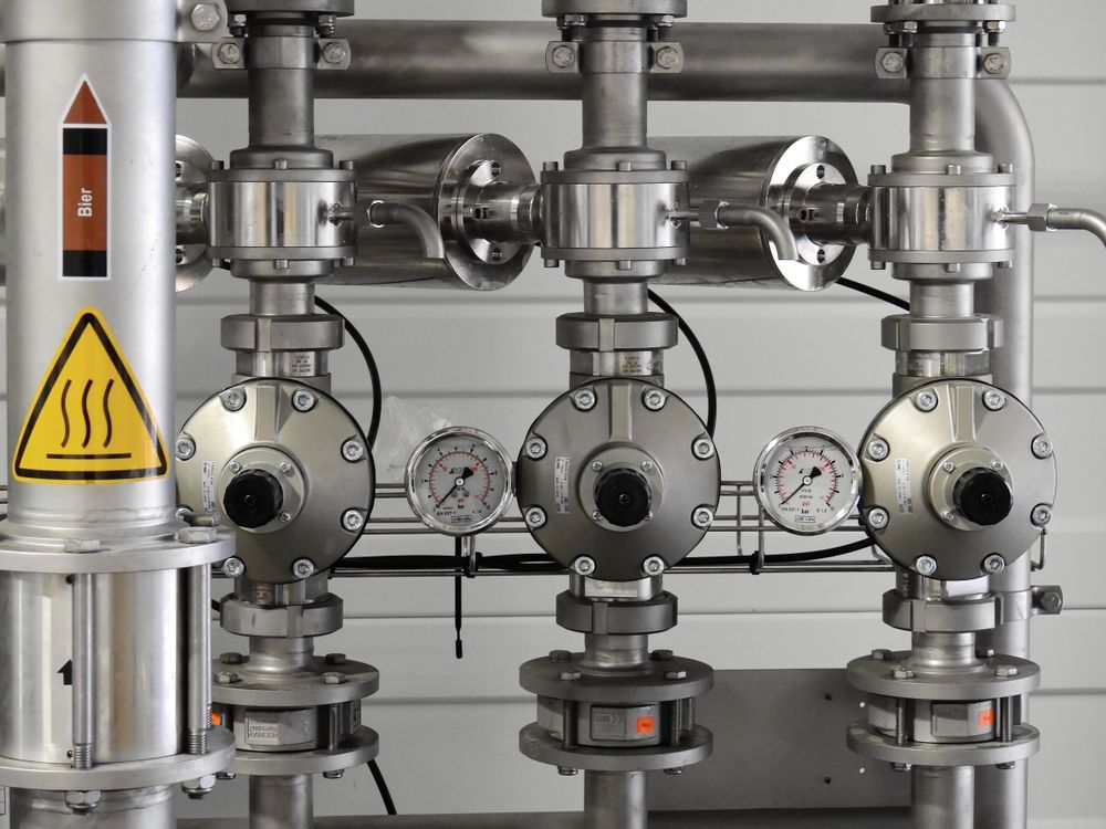 Polished stainless-steel industrial valves and pressure gauges