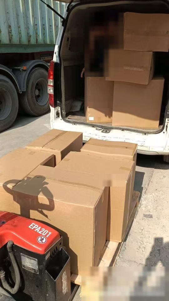 Cartons being loaded onto a van for the port in China