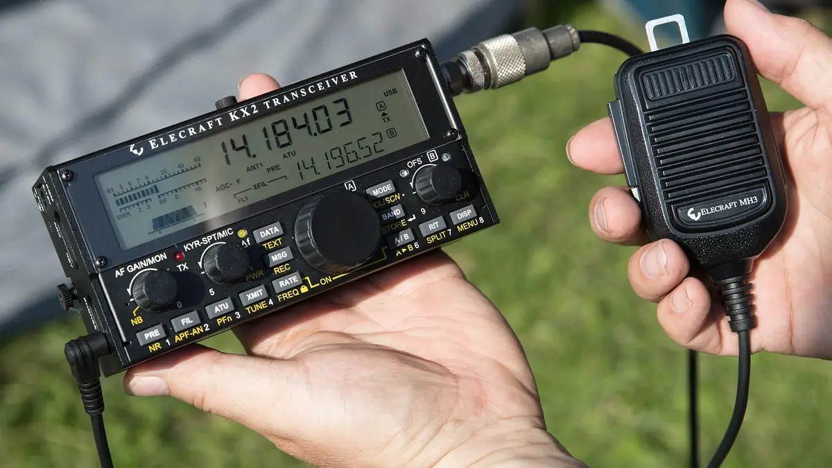A portable amateur radio with a microphone.