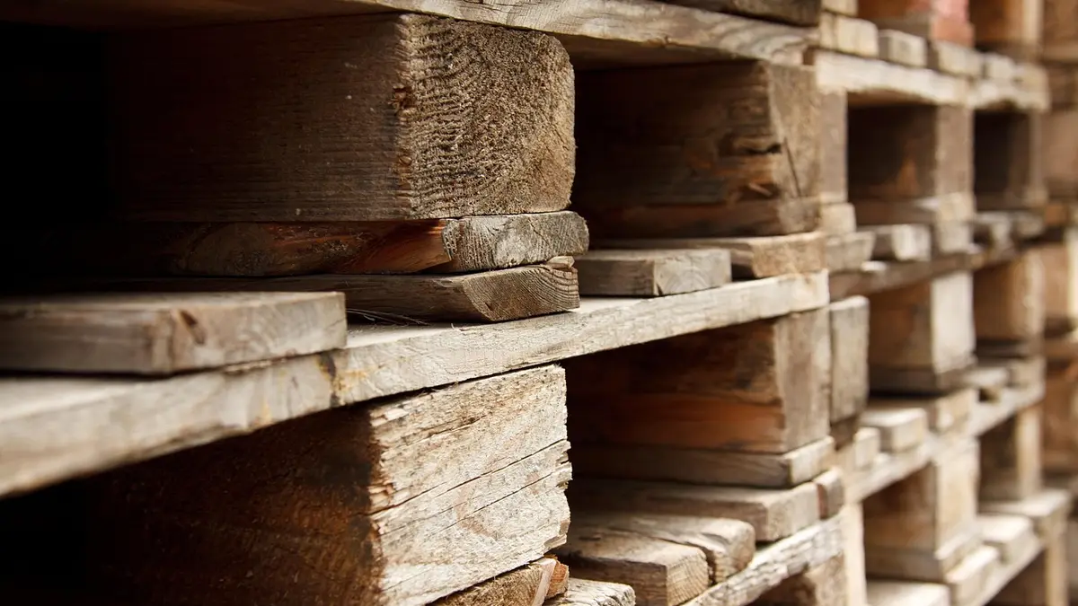 Wooden pallets stacked in a warehouse.