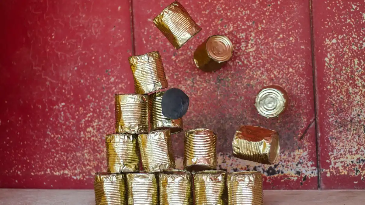 Metal tins used in a fairground throwing game.