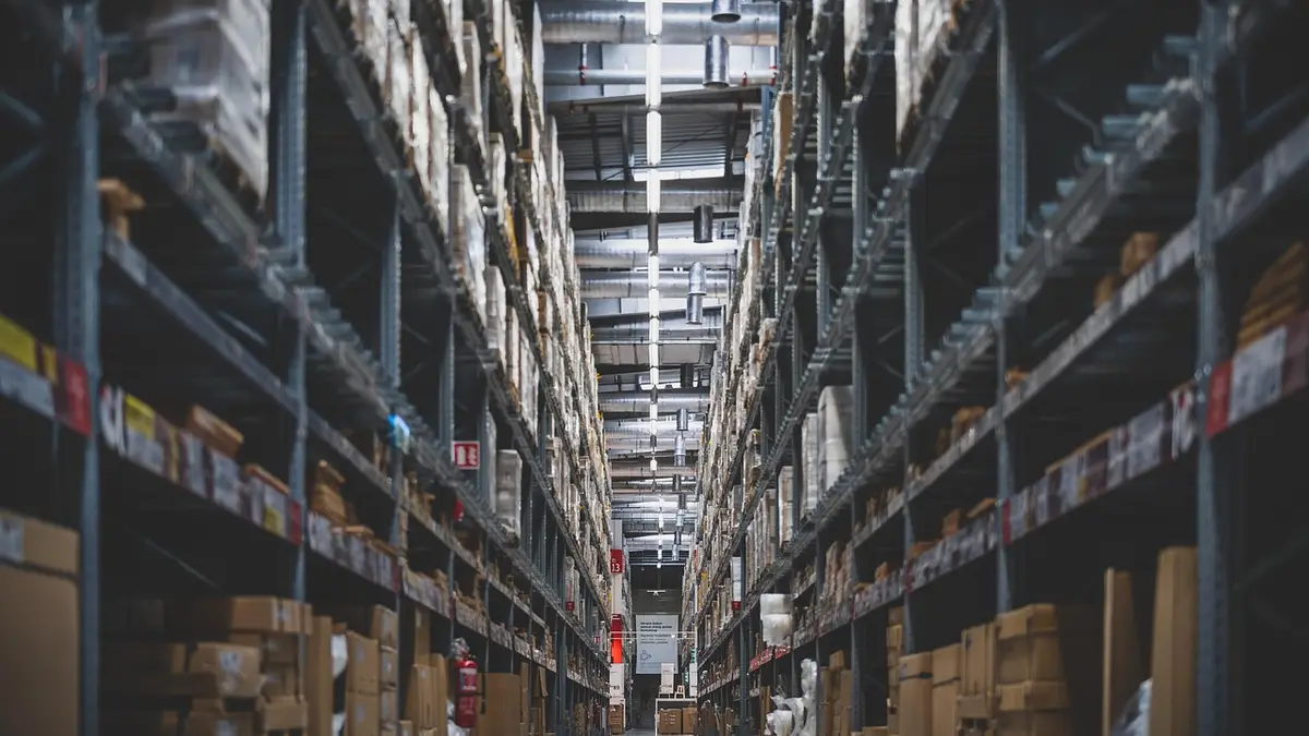 Shelves and stacks of stock in a warehouse.