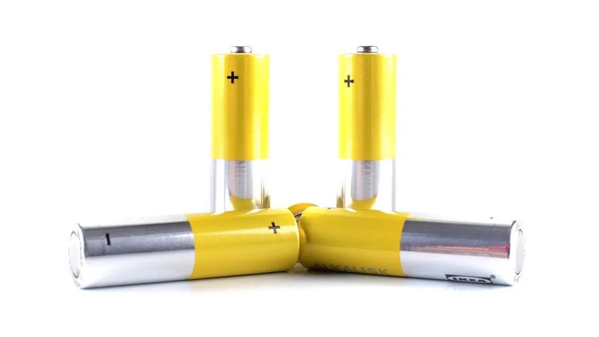 A close-up of a group of AA alkaline batteries.