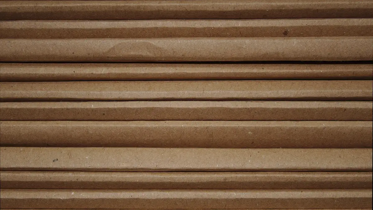 Cardboard packaging material with a textured surface.