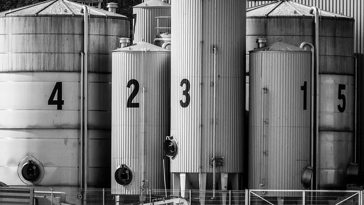 Silos and a storage warehouse in black and white.