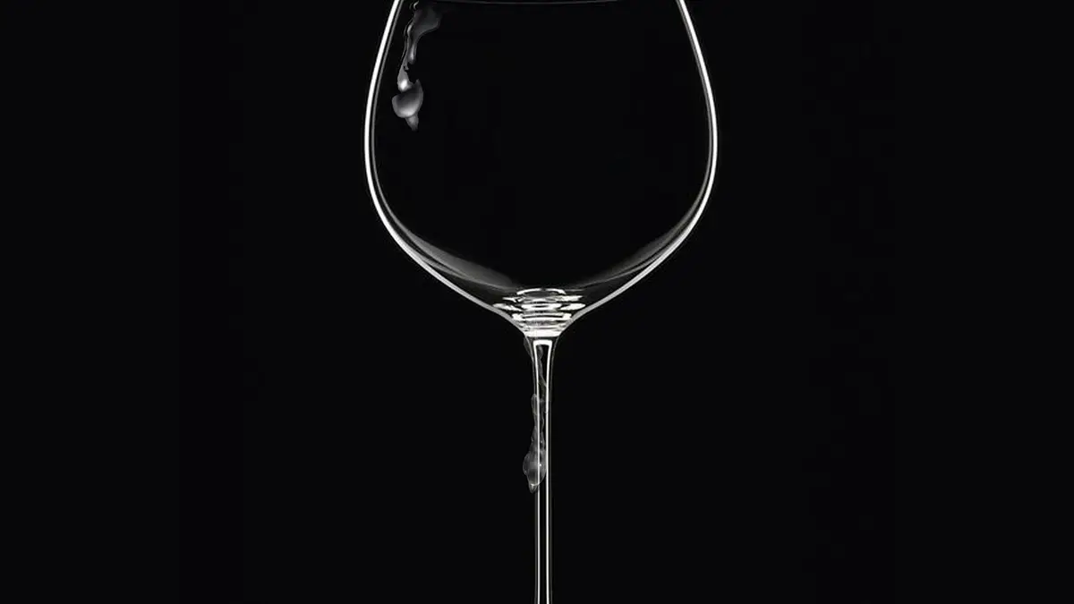 A decorative wine glass against a dark background.