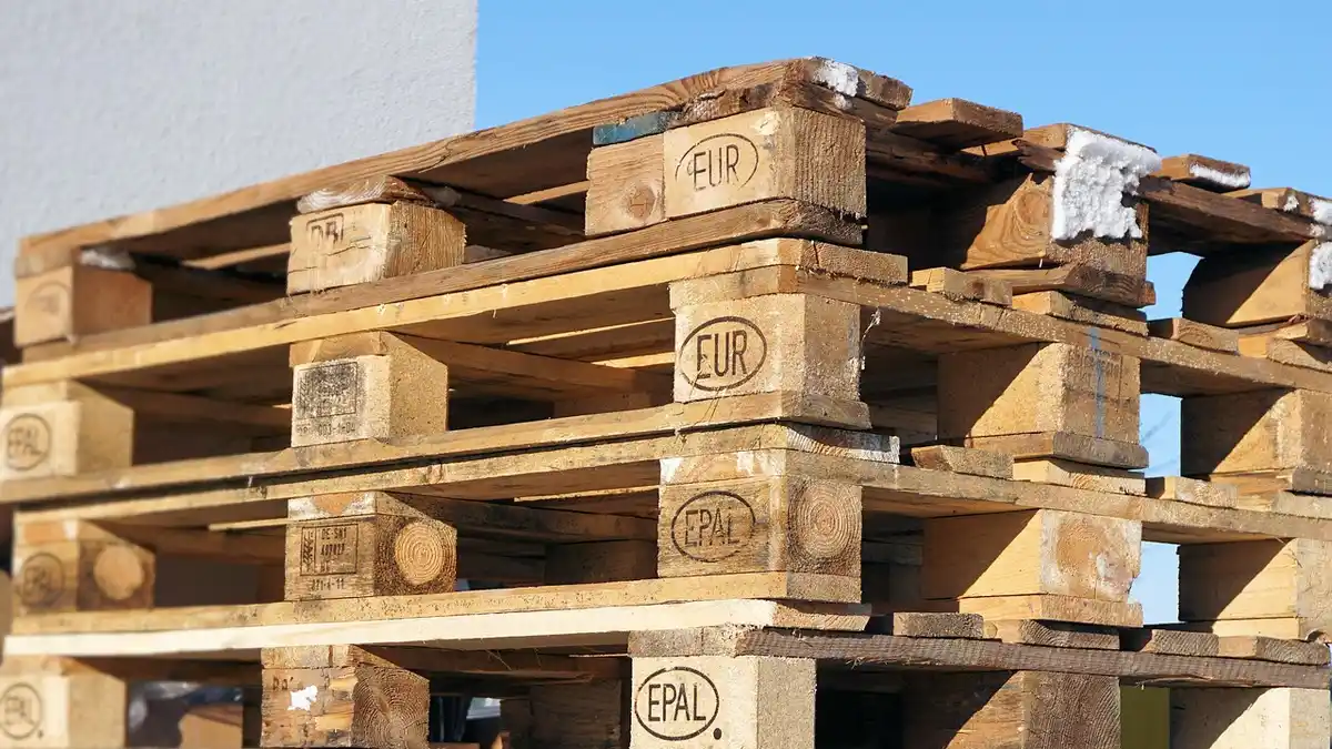 Stacked empty wooden Euro pallets used for freight transport.