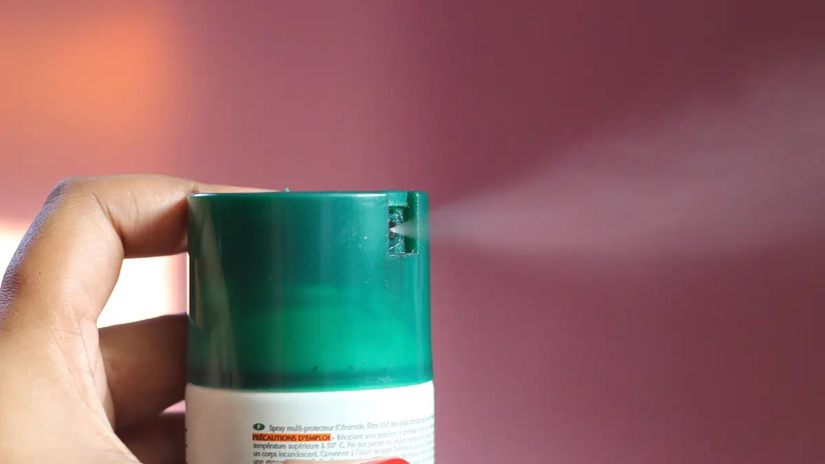 A deodorant spray container with a cap.