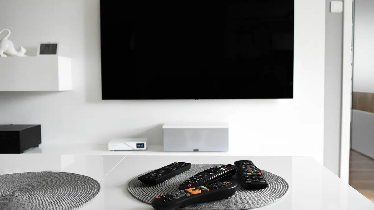 A television and remote control in a living room.
