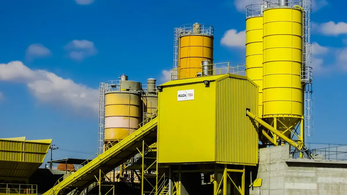 A concrete batching plant with machinery for ready-mix concrete production.
