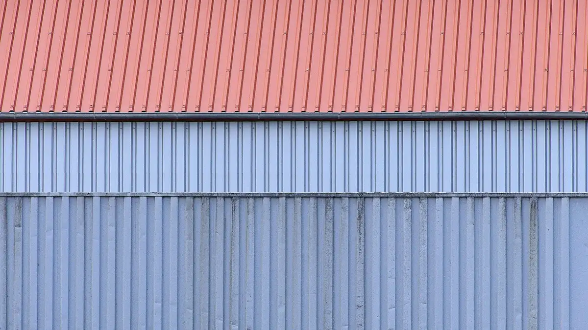 Corrugated aluminium sheet with a ridged metal surface.