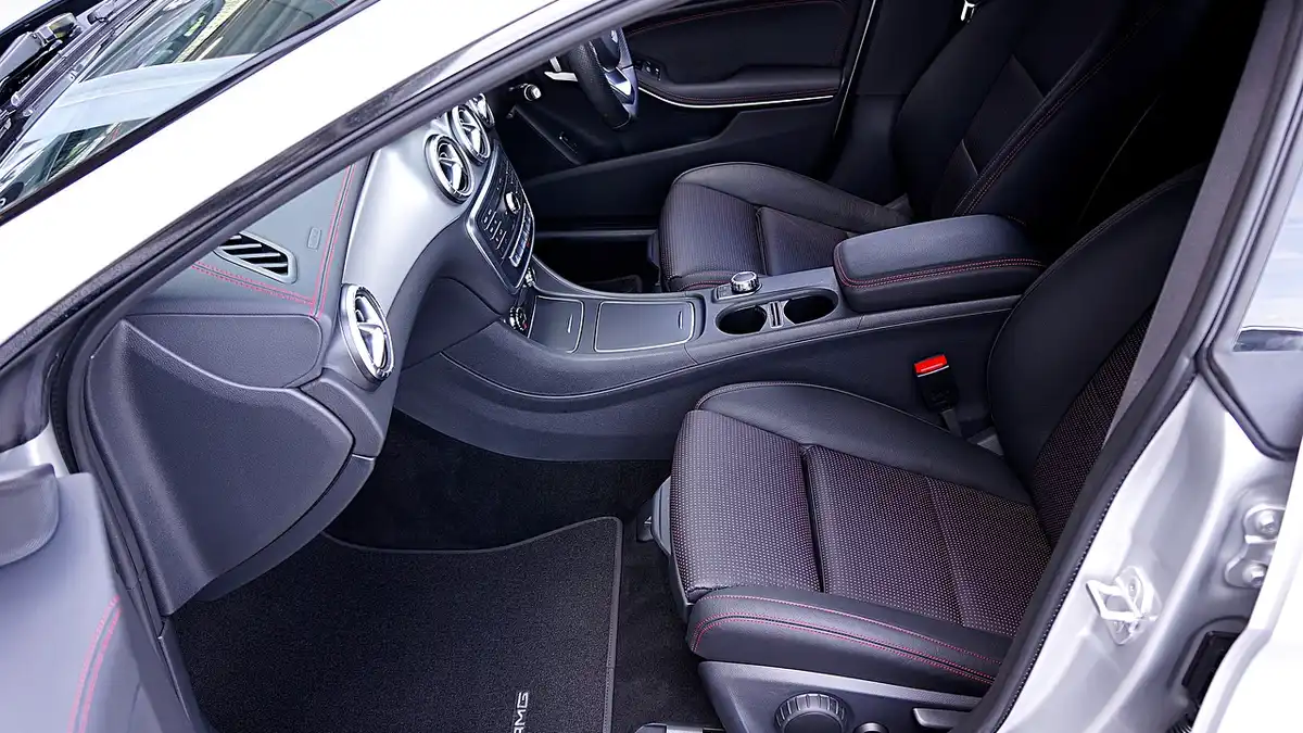 Car interior with a fitted floor mat in the footwell