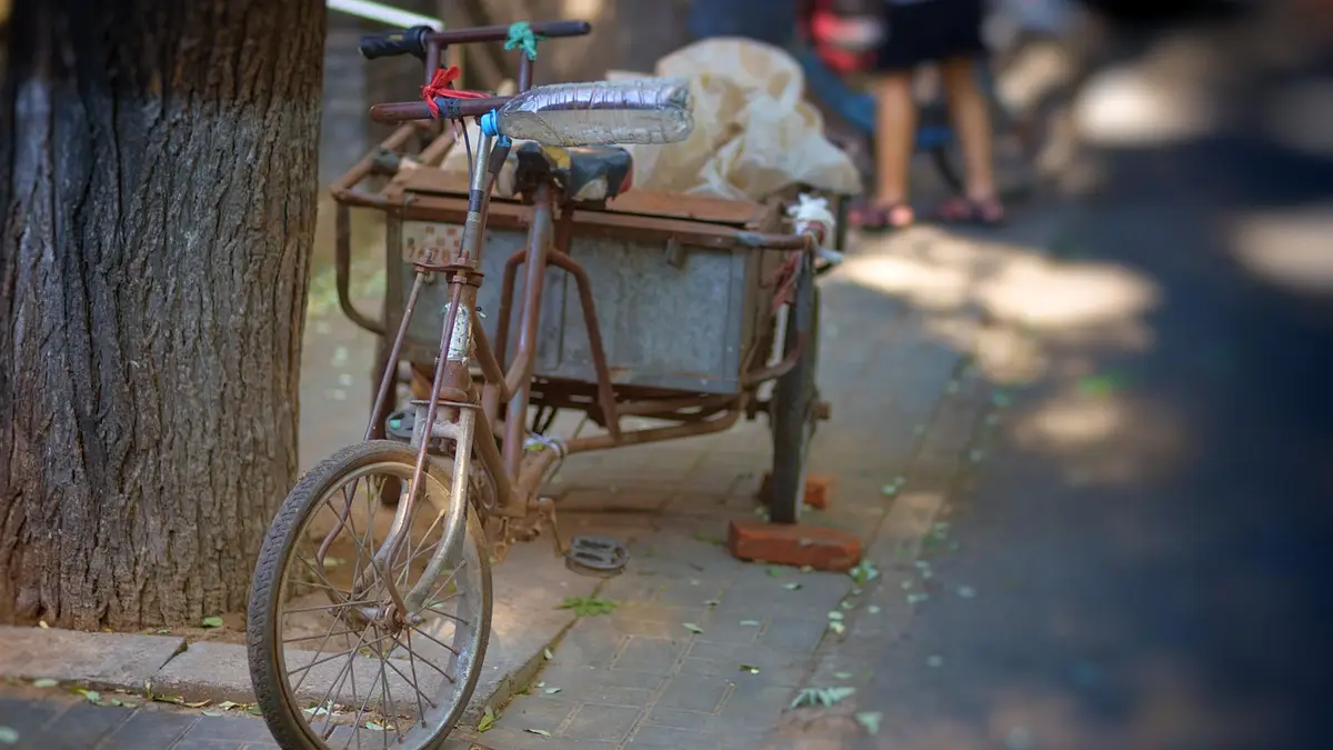 A cargo tricycle on a road in a Beijing hutong.