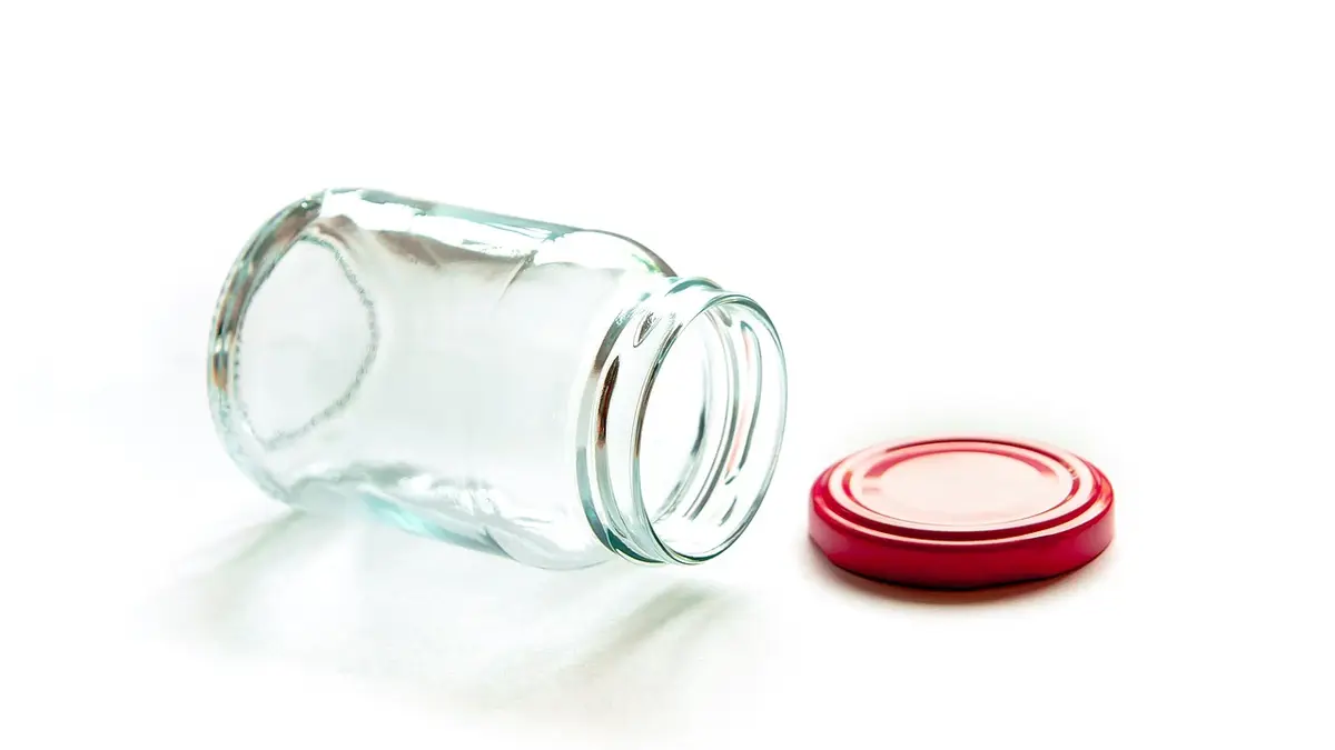An empty, transparent glass jar.