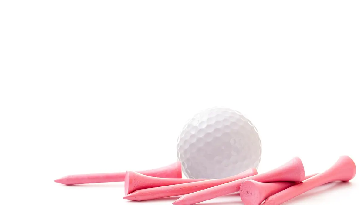 Pink golf tees and a golf ball.