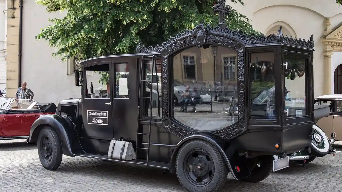 An antique hearse used for coffin transport.