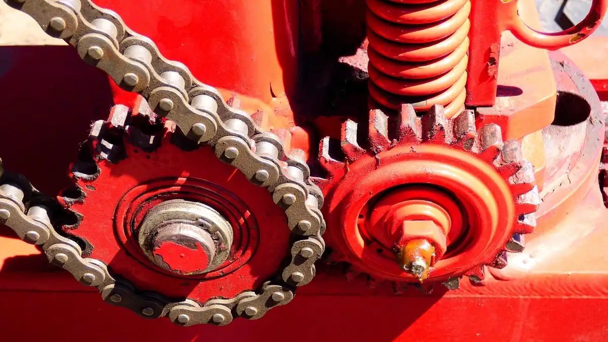 A chain and sprockets on agricultural machinery.