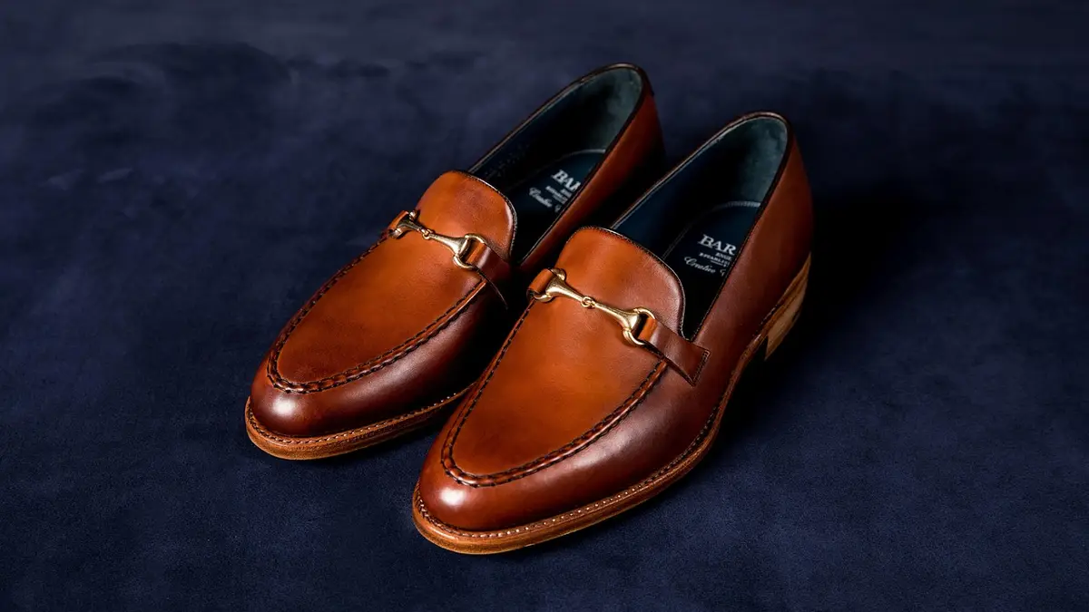 A pair of brown leather penny loafers.