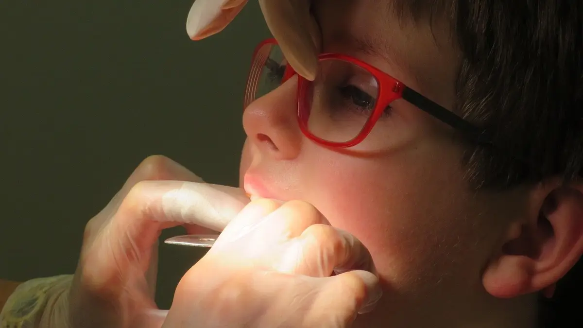 A close-up of a child's teeth with orthodontic brackets.