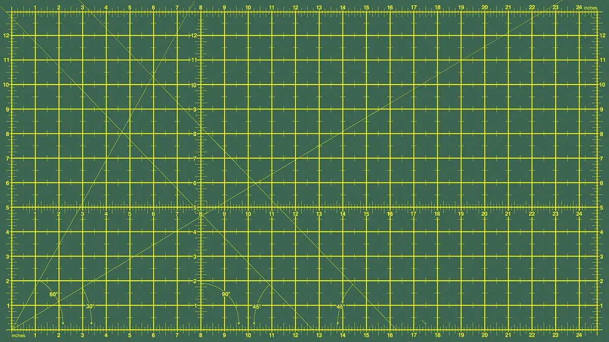 A cutting mat with fabric and sewing tools.