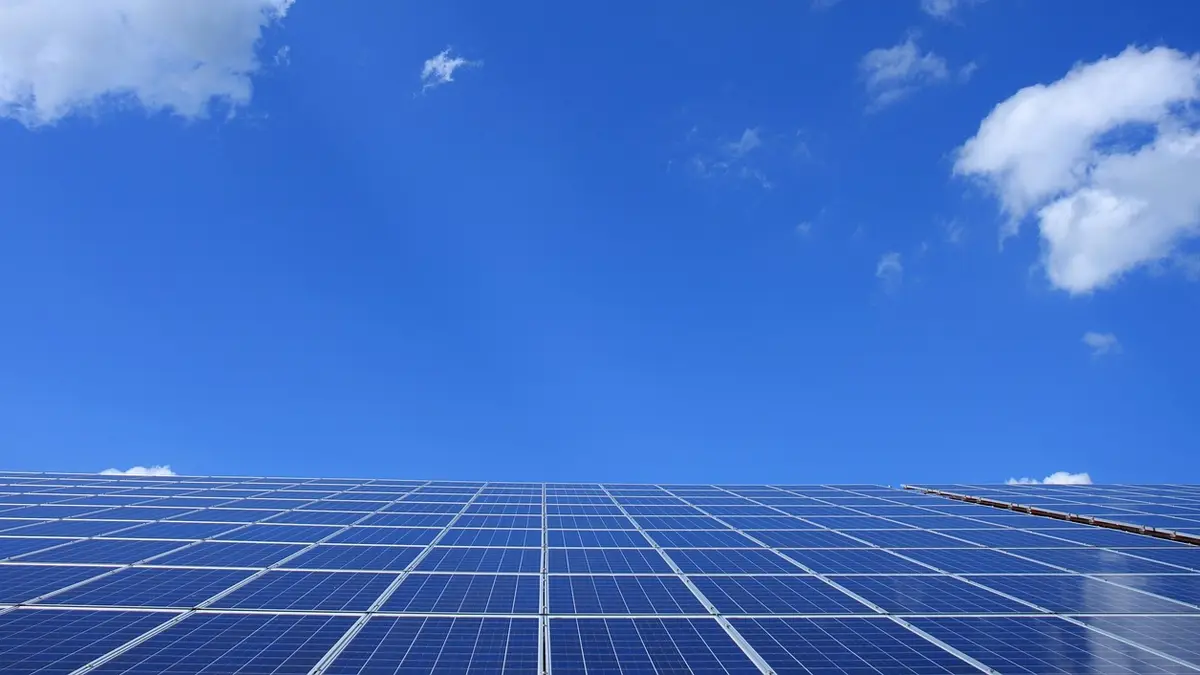 Photovoltaic panels on a steel mounting frame under a blue sky