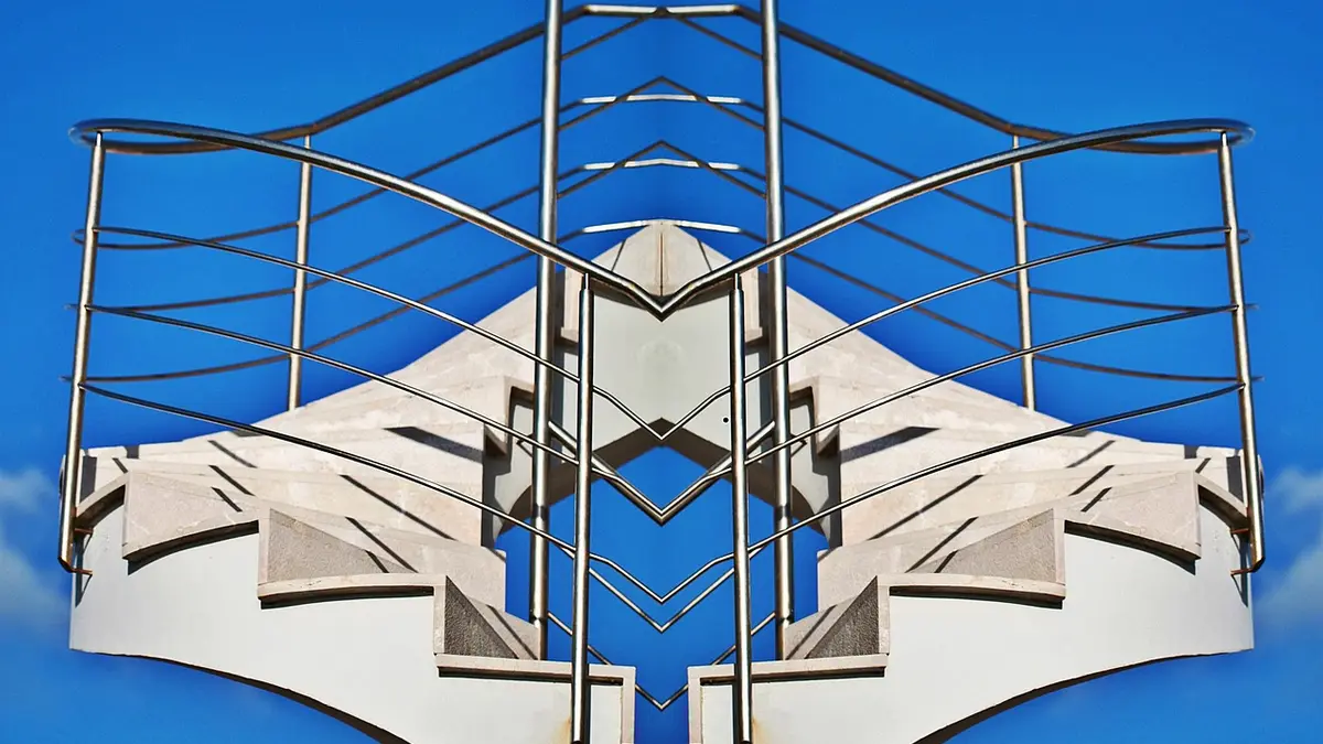 A stainless steel spiral staircase with metal railings.