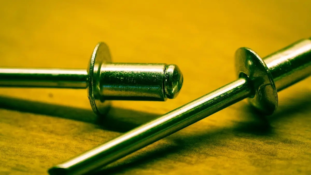 Pop rivets connect parts of a metal frame.