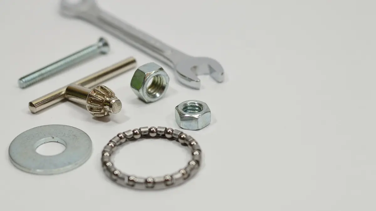 A close-up of steel washers, nuts and screws.
