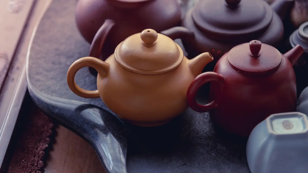 A teapot and a ceramic cup.