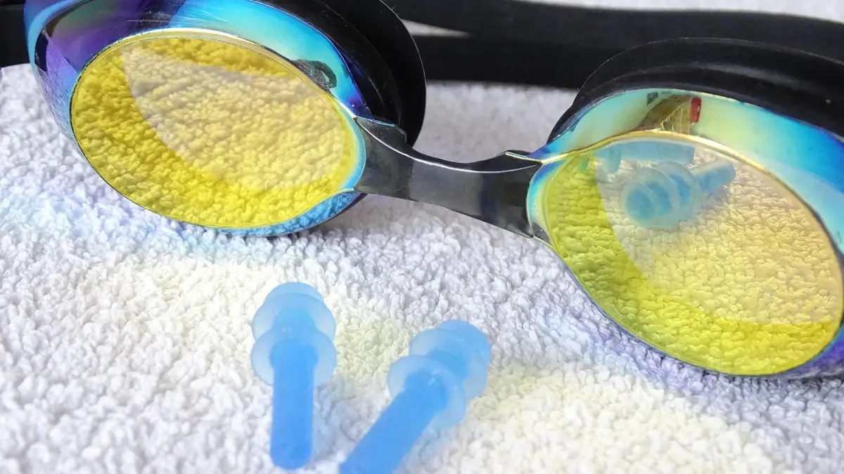 Swimming goggles, earplugs and a bath towel.
