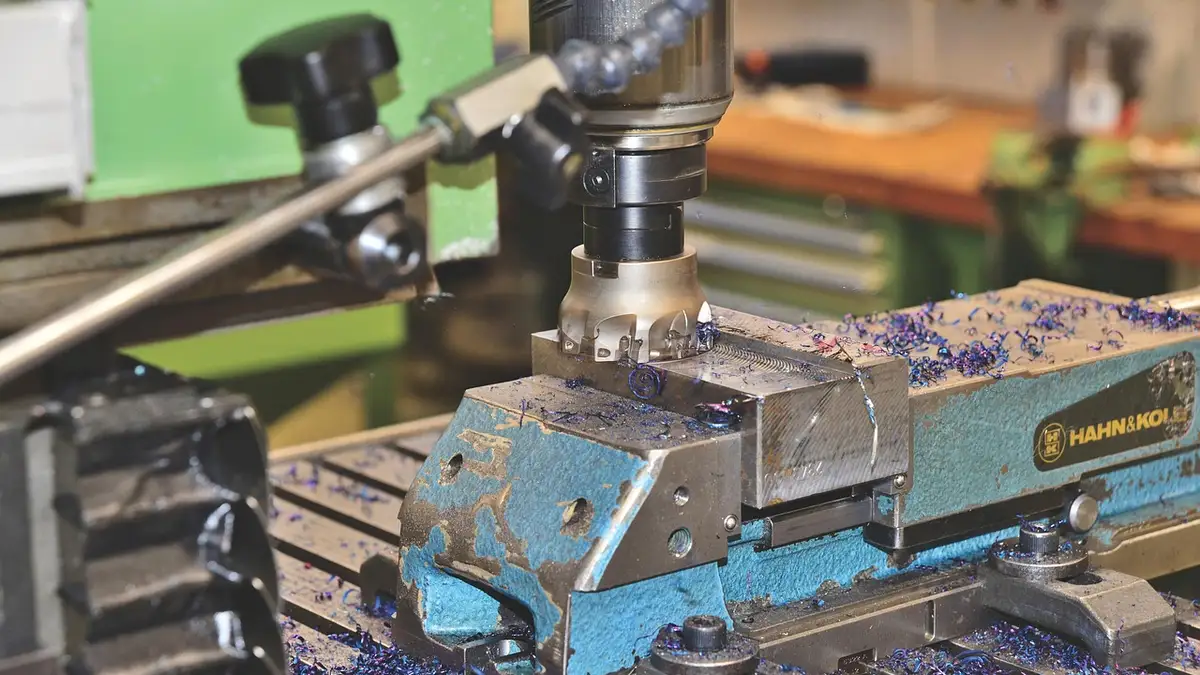 A milling cutter on a machining tool with metal shavings.