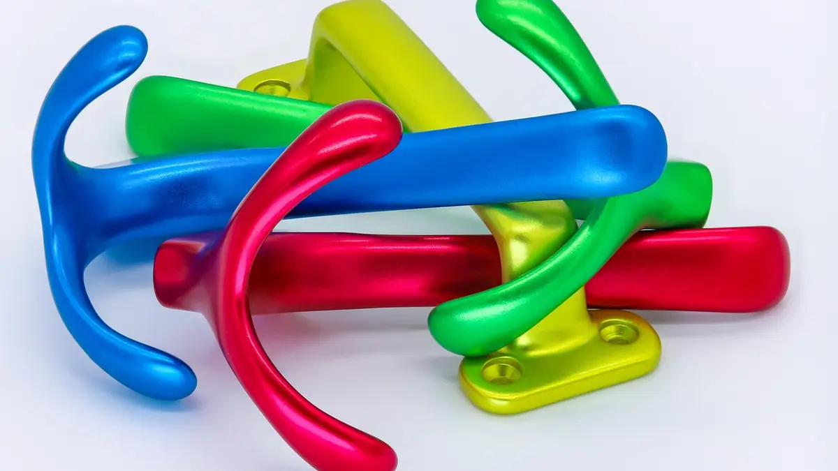Coloured anodized aluminium hooks and coat rack components.
