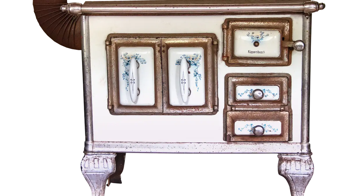 An old enamel kitchen stove with a stove pipe, used for wood or coal fires.